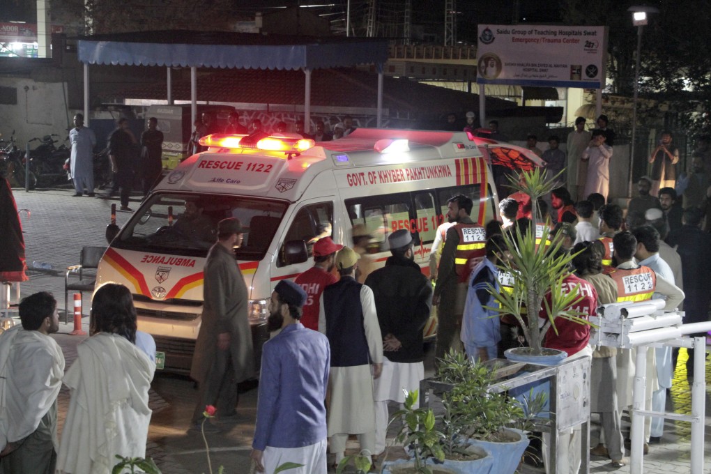 Rescuers help earthquake victims from an ambulance in Pakistan, following a magnitude 6.5 earthquake. Photo: AP
