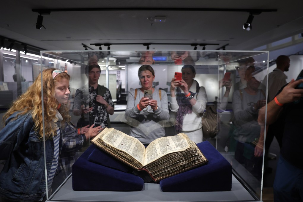 Visitors look at the Codex Sassoon, the oldest complete Hebrew Bible, on display at the ANU Museum of the Jewish People in Tel Aviv, Israel on Wednesday. Photo: EPA-EFE