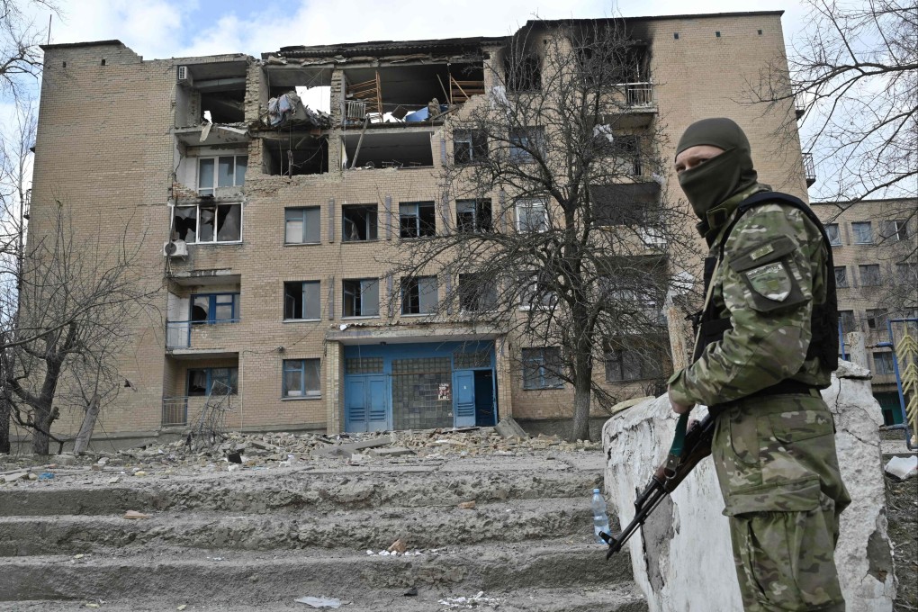 A Ukrainian police officer stands in front of a partially destroyed building after an air strike in the town of Rzhyshchiv, in Ukraine’s Kyiv region on Wednesday. Photo: AFP