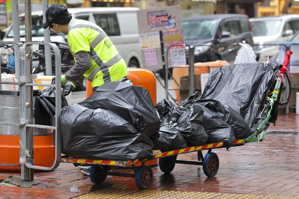 A cleaner empties bins on a street in Mong Kok in January. Photo: Jelly Tse