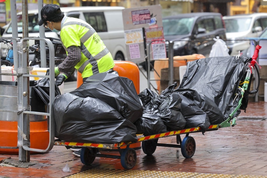 A cleaner empties bins on a street in Mong Kok in January. Photo: Jelly Tse