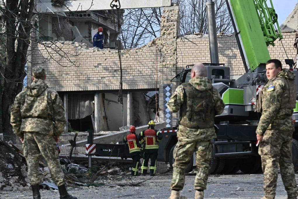 Rescuers clear debris at a partially destroyed building after an air strike in the town of Rzhyshchiv, in the Kyiv region on March 22 amid the Russian invasion of Ukraine. Photo: AFP