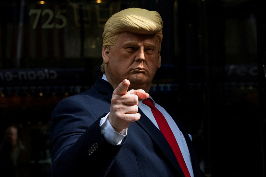 A person wearing a mask depicting former US president outside Trump Tower in New York City. Photo: Reuters