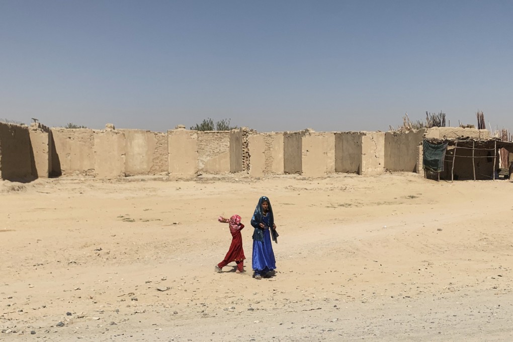 Two girls outside a compound in Kandahar province, Afghanistan. The Taliban are in dire need of foreign aid to fix their war-torn country, but their anti-female laws make them a pariah to the detriment of millions of Afghans. Photo: Lindsey Kennedy