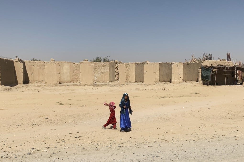 Two girls outside a compound in Kandahar province, Afghanistan. The Taliban are in dire need of foreign aid to fix their war-torn country, but their anti-female laws make them a pariah to the detriment of millions of Afghans. Photo: Lindsey Kennedy