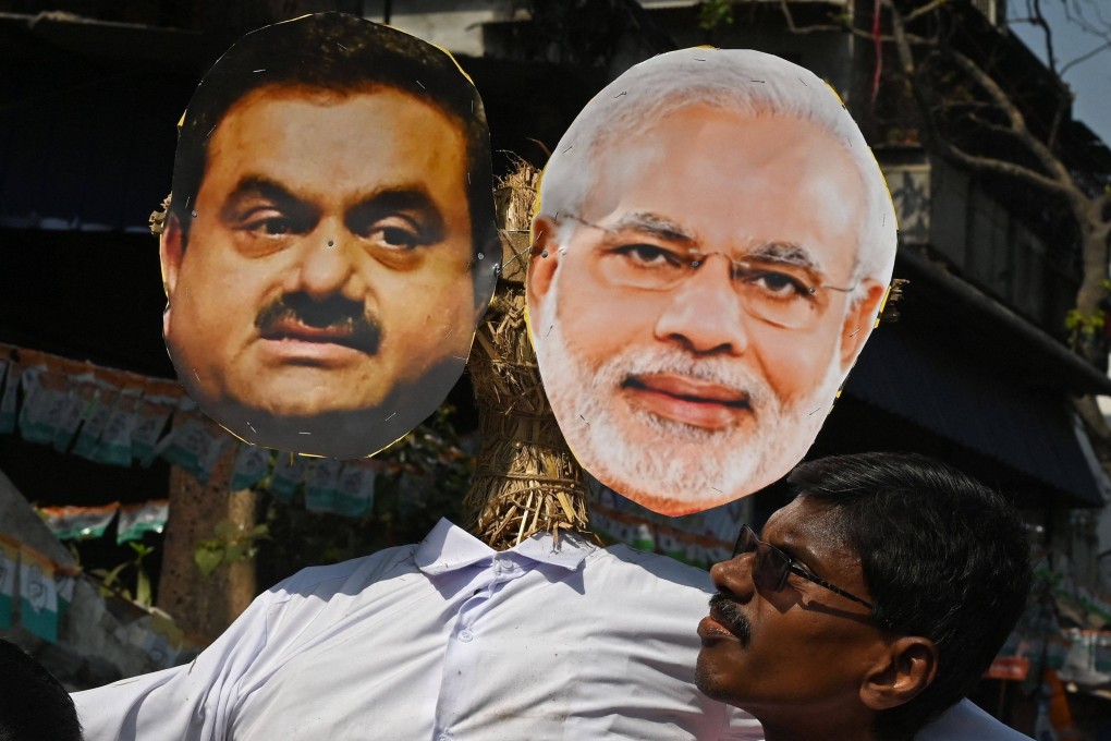 An activist of India’s Congress party carries an effigy of Prime Minister Narendra Modi and Indian tycoon Gautam Adani during a rally organised to protest against the union government’s financial policies. Photo: AFP/File