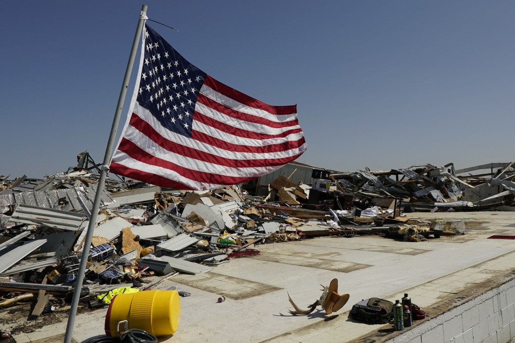 An American flag flies on the slab of what was a DIY shop in Rolling Fork, Mississippi on Saturday morning after tornadoes tore through the state on Friday night. Photo: AP
