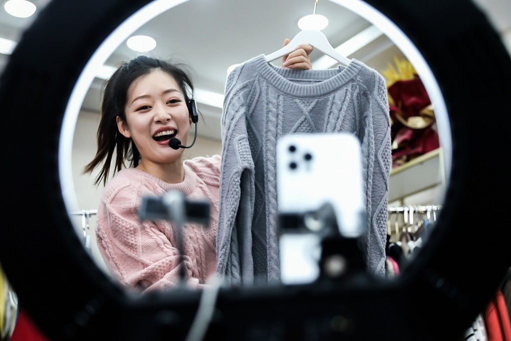 A woman sells clothes via live streaming on a smartphone at an e-commerce park in Linyi, Shandong province. Photo: VCG via Getty Images