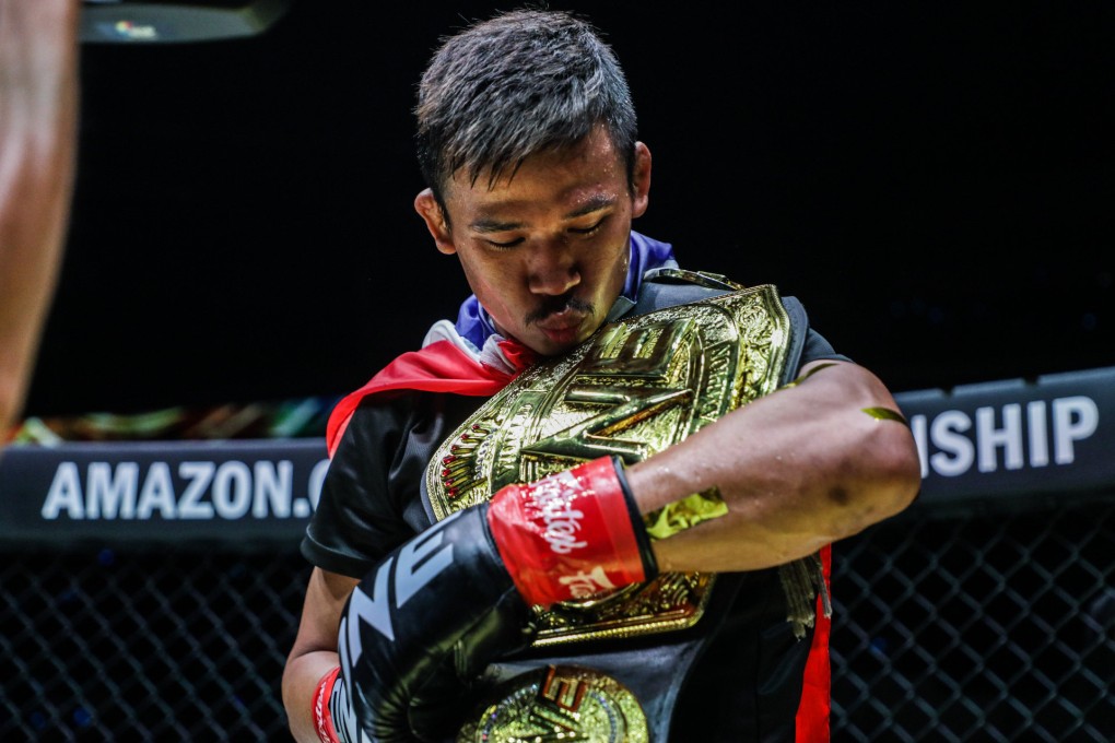 Superlek kisses his flyweight kickboxing title after his win over Danial Williams at ONE Fight Night 8. Photos: ONE Championship