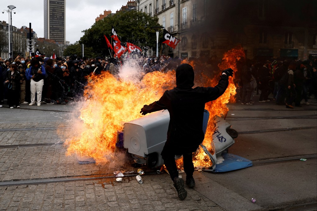 Protesters near burning garbage bins in Nantes, France, amid nationwide strikes and protests against French government’s pension reform. Photo: Reuters