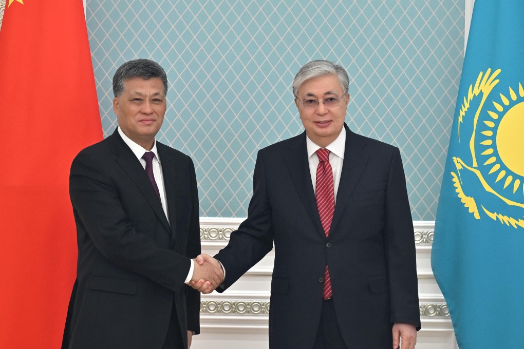Kazakh President Kassym-Jomart Tokayev (right) greets Xinjiang Communist Party boss Ma Xingrui in Astana on Monday. Photo: AFP