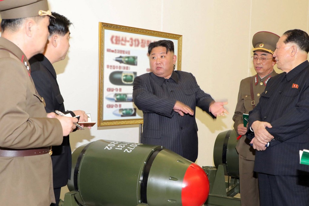 North Korean leader Kim Jong-un (centre) inspects a nuclear warhead. Photo Korean Central News Agency via KNS / AFP