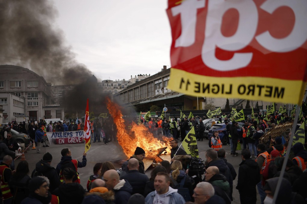 Railway workers take part in a demonstration against government pension reform in Paris on Tuesday. Photo: EPA-EFE
