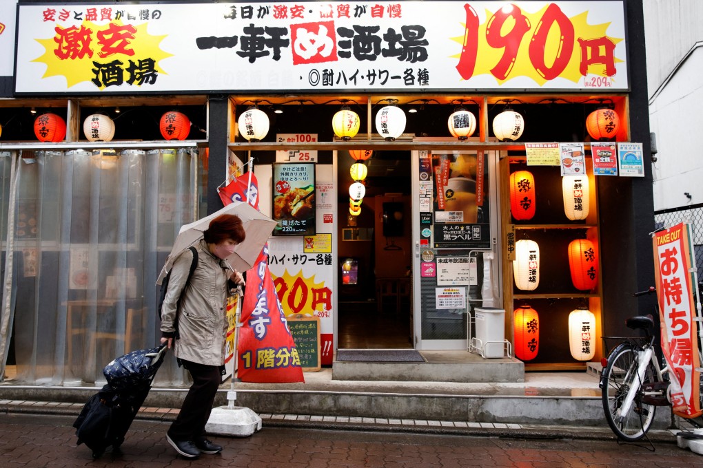 A woman walks in front of a cheap izakaya in Tokyo, Japan, on March 24. The BOJ cannot keep bond yields low and stop the currency from depreciating at the same time. Allowing the currency to weaken will inflate the problem away, and Japan wants inflation anyway. Photo: Reuters