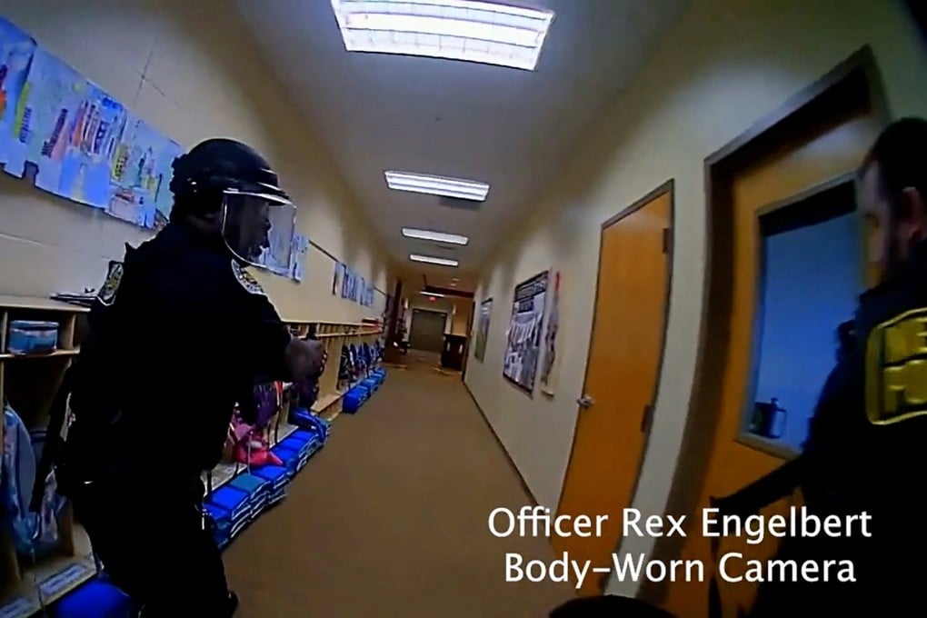 Police officers search for the mass shooting suspect in The Covenant School, in a still image from body camera video in Nashville, Tennessee, on Monday. Photo: Metropolitan Nashville Police Department via Reuters