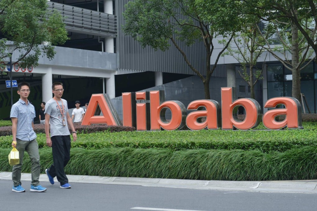 Employees walking past the logo of Alibaba at its headquarters in Hangzhou, China’s eastern Zhejiang province. Photo: AFP