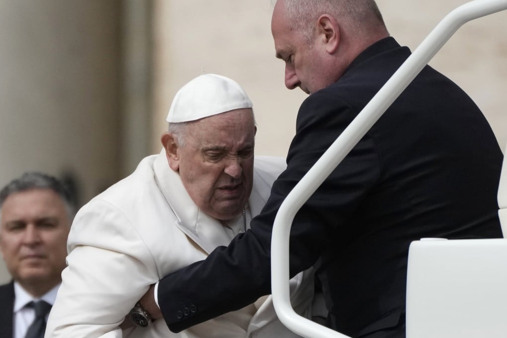 Pope Francis being helped into his car at the Vatican on Wednesday. Photo: AP