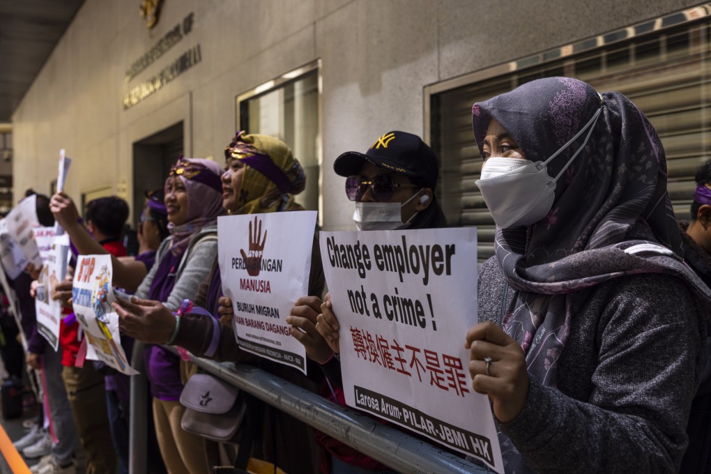 Domestic workers gather outside the Indonesian consulate in Hong Kong on March 5, carrying placards in favour of migrant workers’ rights. Photo: AP