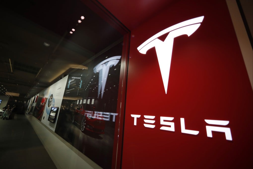 A sign bearing the Tesla company logo is displayed outside a Tesla showroom in Denver, Colorado. Photo: AP Photo