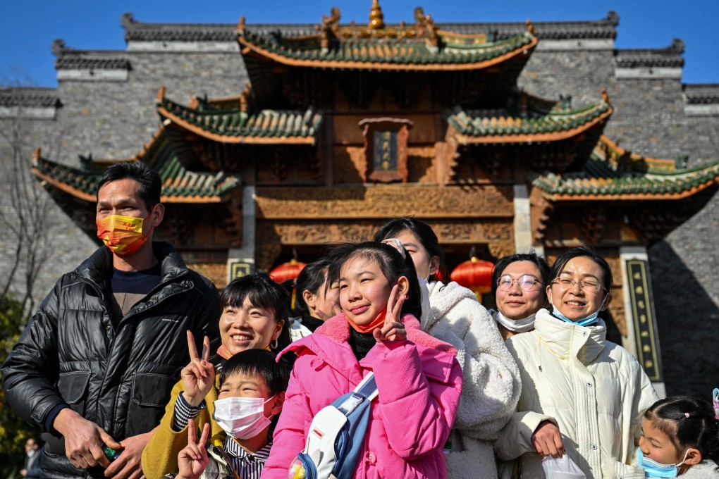 Visitors pose for a picture at Wuhan Garden Expo-Hankouli in Wuhan, in China’s central Hubei province on January 24, 2023, during the Lunar New Year holidays. Photo: AFP