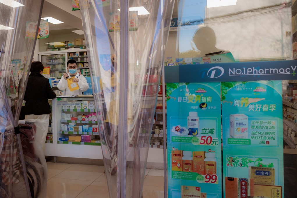 A woman buys medicine in a pharmacy in Shanghai on March 10. In China, 84 per cent of pharmacies still provide antibiotics without prescriptions. Photo: EPA-EFE