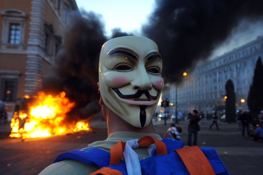 A masked protester at a protest in Rome on October 15, 2011, against the greed of bankers, in what was the worst violence of worldwide demonstrations against corporate greed in the aftermath of the global financial crisis. Photo: AFP