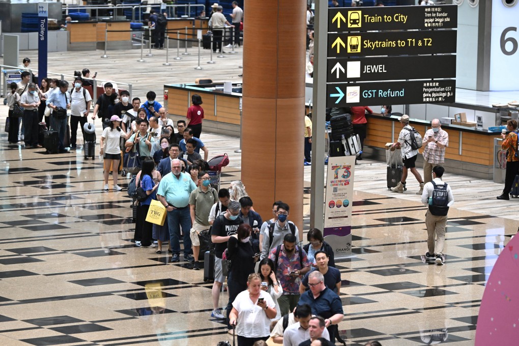 Passengers queue at the departure hall of Changi Airport Terminal 3 in Singapore on March 31, 2023. The Straits Times/Lim Yaohui via Reuters