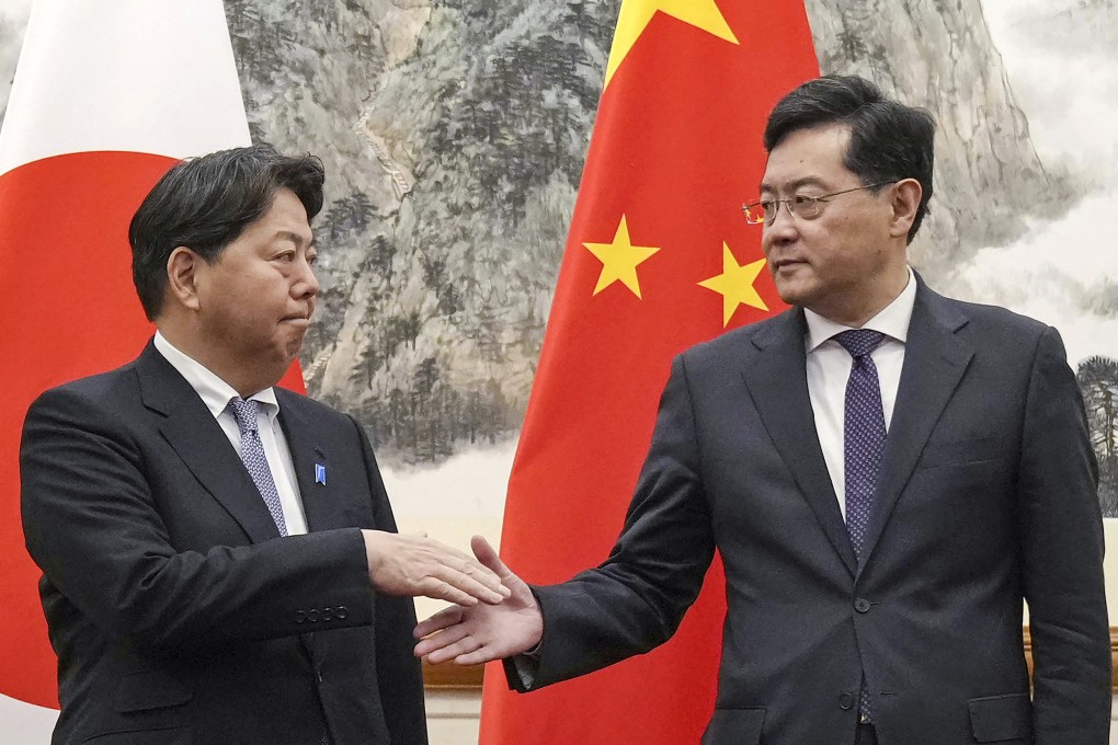 Japanese Foreign Minister Yoshimasa Hayashi (left) greets his counterpart Qin Gang at the Diaoyutai State Guest House in Beijing on Sunday. Photo: Kyodo News via AP