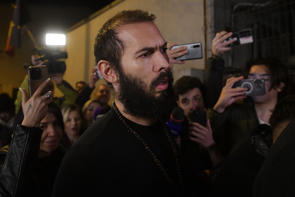 Young fans and media surround internet personality Andrew Tate as he leaves a police detention facility in Bucharest, Romania, after his release from prison on Friday. Photo: AP