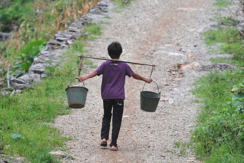 A villager goes uphill to get water in Nongyong village, southern China’s Guangxi Zhuang Autonomous Region. Photo: Xinhua
