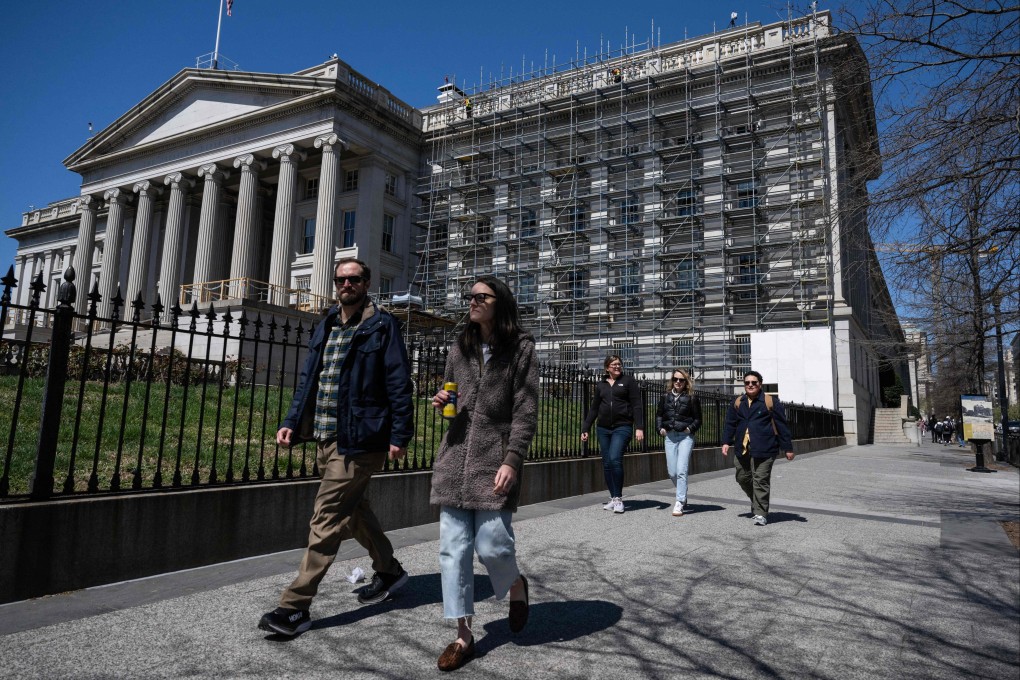 People walk past the US Department of the Treasury in Washington on March 30. China has moved to reduce its holdings of US Treasuries in recent months, but good alternatives for Chinese investment are few and far between. Photo: AFP