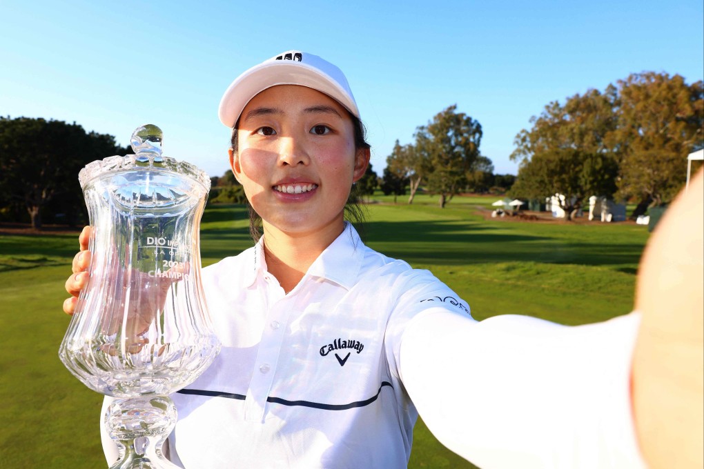 PALOS VERDES ESTATES, CALIFORNIA - APRIL 02: Yin Ruoning imitates a selfie as she poses with the trophy after winning the LA Open. Photo: AFP