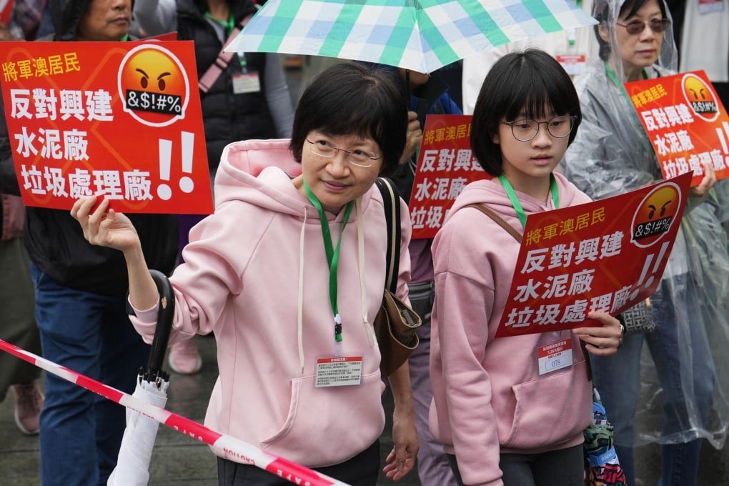 Participants in a rally at Tseung Kwan O march with numbered lanyards as police keep a close watch. Photo: Elson Li