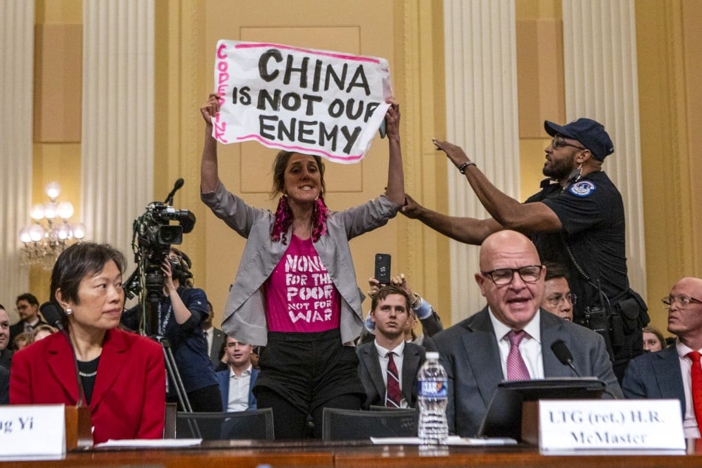 A demonstrator interrupts witness testimony during a hearing of the House Select Committee on the Strategic Competition Between the United States and the Chinese Communist Party, in Washington on February 28. Photo: Bloomberg