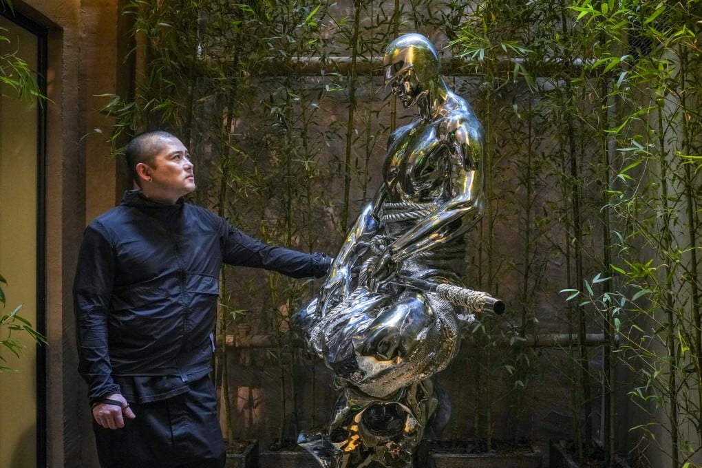 Sculptor Ren Zhe with one of his sculptures at an exhibition organised by Wheelock Properties in Hong Kong recently. Photo: Elson Li