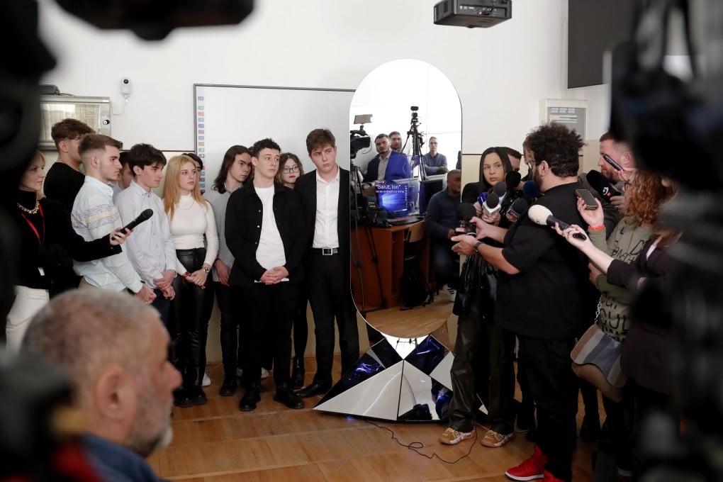 AI robot “ION” interacts with the students of Aurel Vlaicu National College in Bucharest, Romania, on March 13. ION is an honorary government adviser, created by the AI and research community and universities in Romania to collect and represent the wishes, thoughts and problems of Romanians to the government. Photo: EPA-EFE