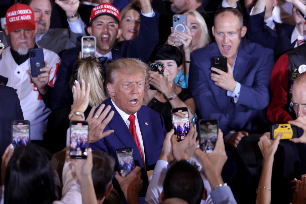 Former US President Donald Trump arrives at his resort Mar-a-Lago in Florida on Tuesday, surrounded by supporters. Earlier in the day, Trump pleaded not guilty to 34 felony counts in New York. Photo: Getty Images via TNS