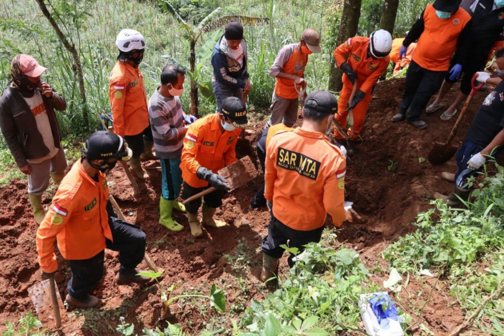 Police in Central Java, Indonesia, investigate a piece of land where 12 bodies were found, near the home of a shaman. Photo: Central Java police