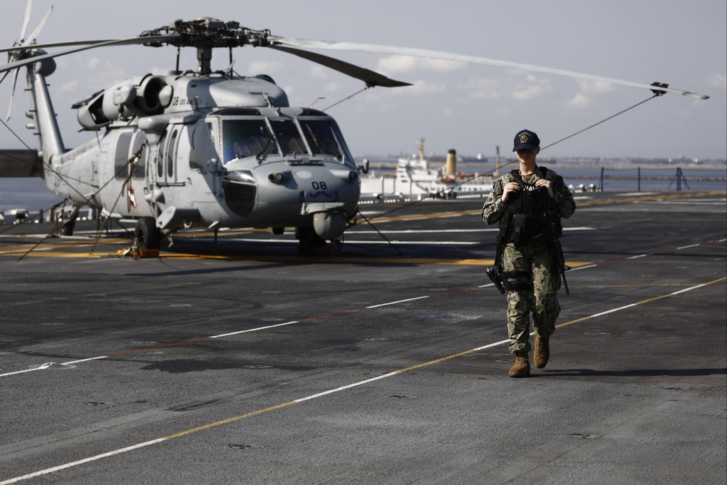 An armed US sailor patrols the deck of the USS America amphibious assault ship docked at the Port of Manila in the Philippines last month. Photo: EPA-EFE