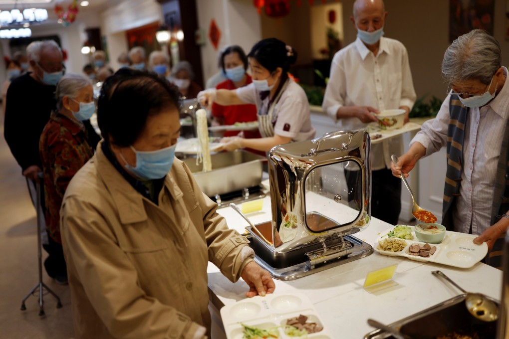 Elderly residents of a care home help themselves at a buffet lunch in Beijing in 2021.
As China’s population ages, the health system should focus more on disease prevention. Photo: Reuters