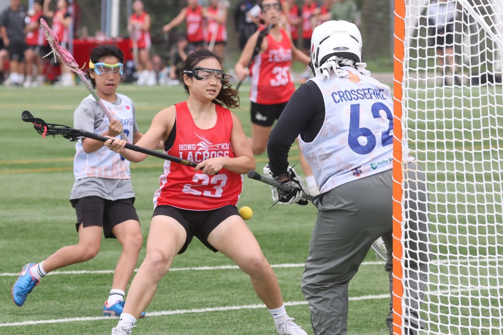 Hong Kong player Claudia Chie Tsze-tung (centre) in action against Singapore club Crossfire during the second day of the 2023 Hong Kong Lacrosse Open, Photo: Yik Yeung-man