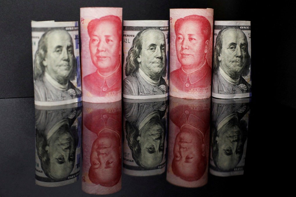 Banknotes of the Chinese yuan and the US dollar. Photo: Reuters