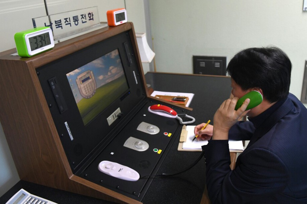 A South Korean official talks on the phone with a North Korean counterpart 
using a communications link at the border village of Panmunjom between the two Koreas. Photo: South Korea Unification Ministry/Yonhap via AP