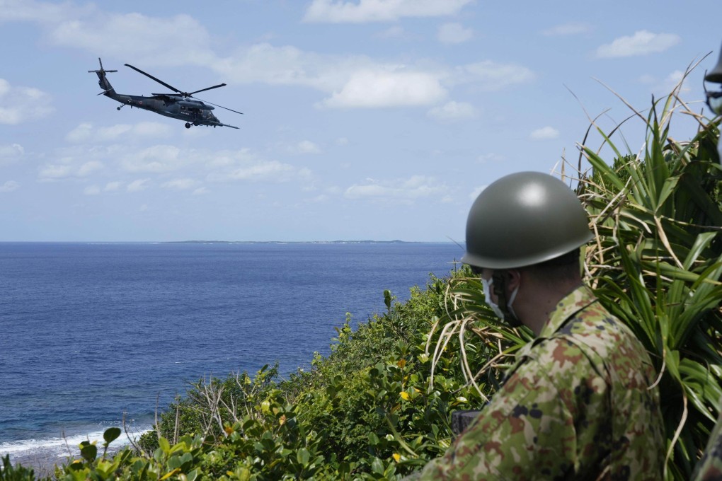 A Japanese military helicopter searches off Miyako island, Okinawa prefecture, on April 9, for a chopper that went missing last week. Photo: Kyodo