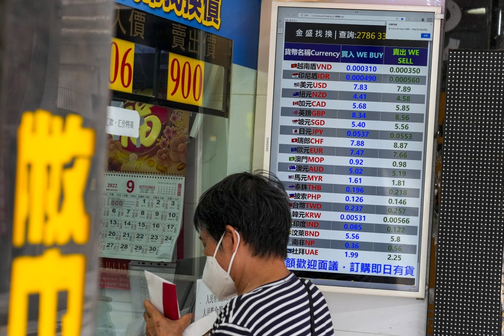 People queue up for change money outside a currency exchange shop at Sheung Wan.      Photo: Sam Tsang