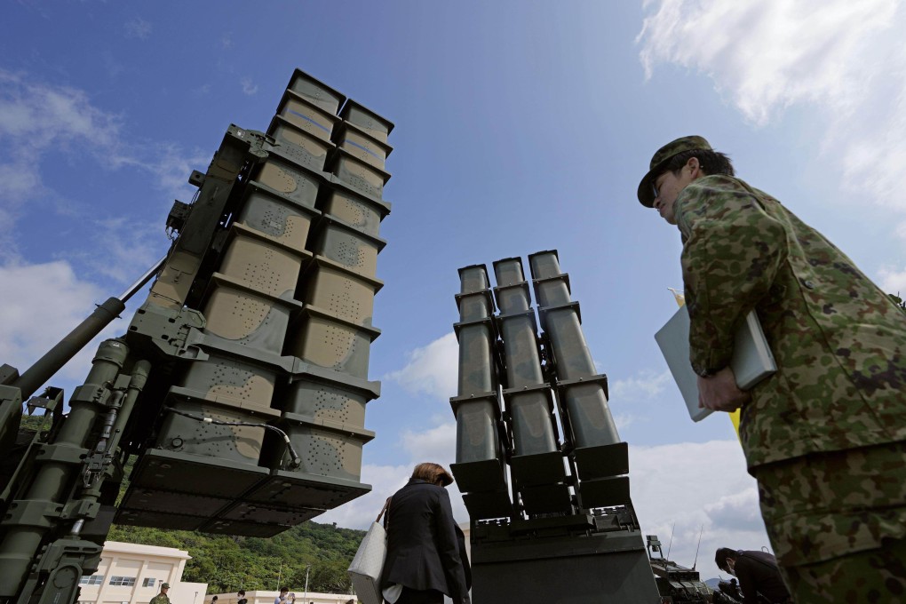 A Japanese Type-3 medium-distance surface-to-air missile launcher (left) and a Type-12 surface-to-ship missile launcher are seen during a ceremony marking the opening of a new garrison in Okinawa prefecture, southern Japan, this month. Photo: Kyodo