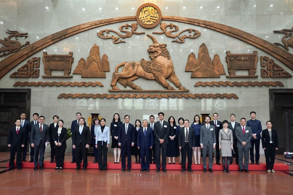 The Bar Association delegation takes a group photo at the Supreme People’s Court with its vice-president Yang Wanming. Photo: Handout