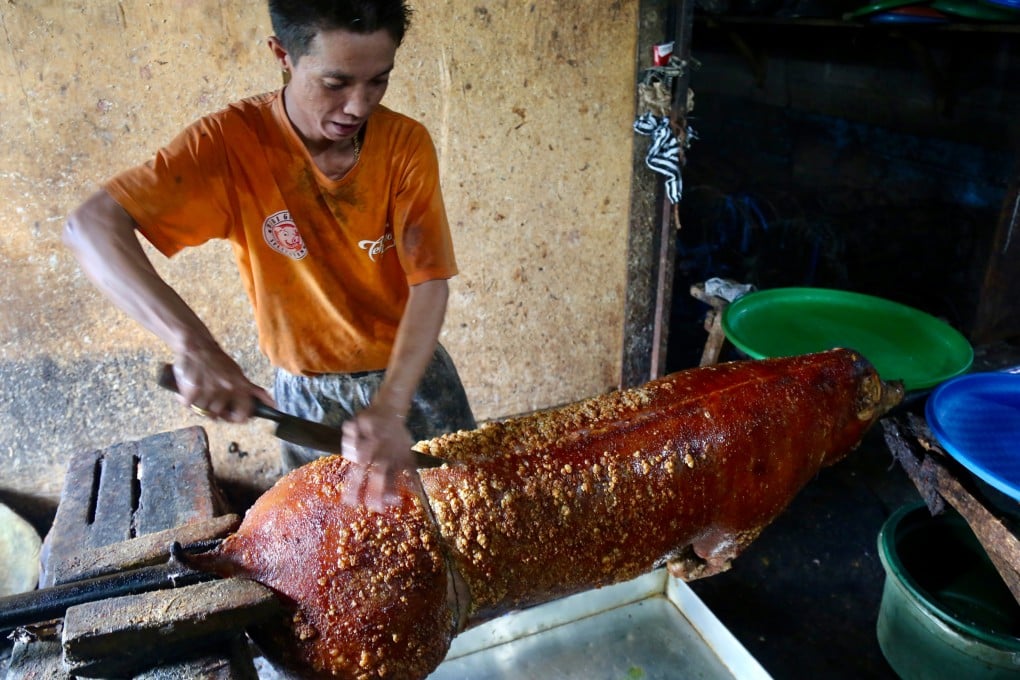 Carving a spit-roasted pig at Babi Guling Slingsing, in Pengayehan on Bali’s west coast. “Babi guling”, or turning pig, is an iconic Balinese dish the late food legend Anthony Bourdain rated as the most succulent pork he ever tasted. Photo: Ian Lloyd Neubauer