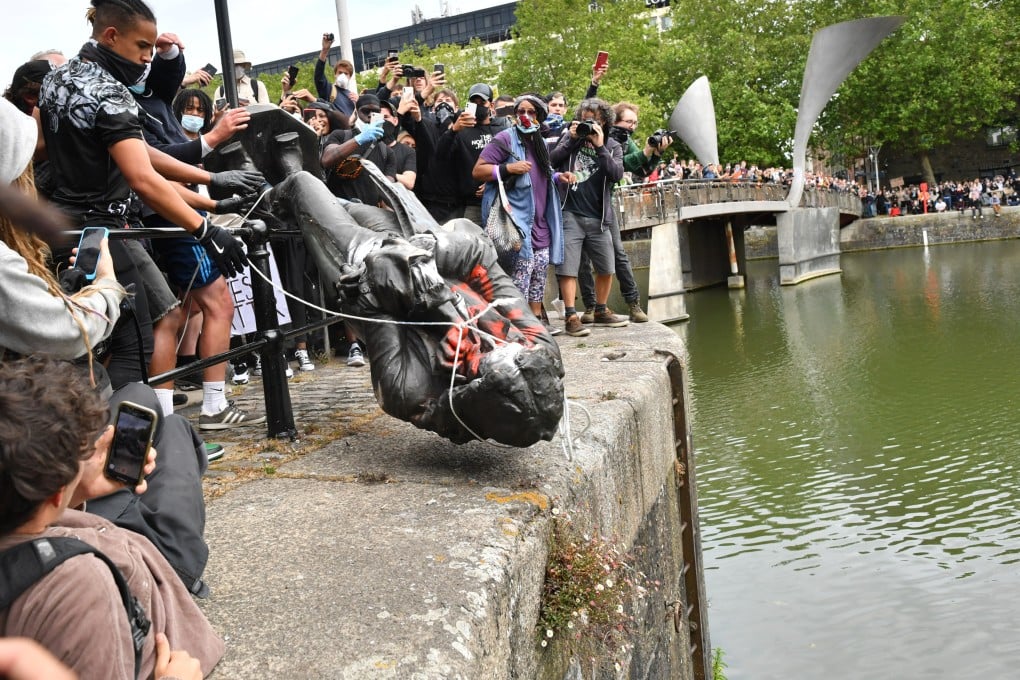 Protesters in England throw a statue of slave trader Edward Colston into Bristol harbour. Might a statue of opium trader H.N. Mody outside the Main Building of the University of Hong Kong suffer a similar fate? Only time will tell. Photo: Getty Images
