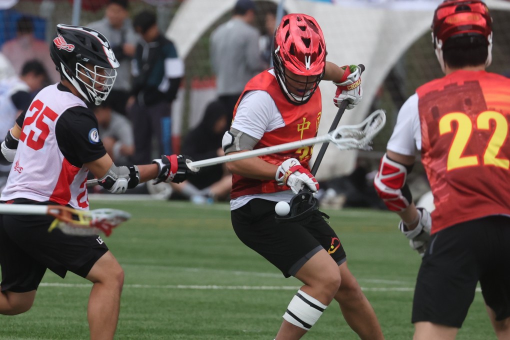 Hong Kong player Lin You-run (L) vies for the ball with China player Greg Wang during the second day of Hong Kong Lacrosse Open at HKFA Football Training Centre, Tseung Kwan O. 08APR23 SCMP/ Yik Yeung-man